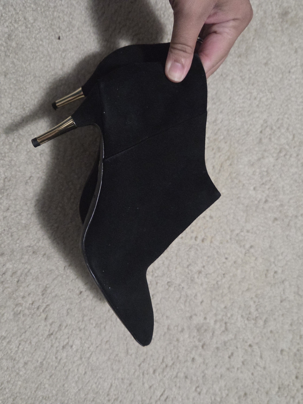Brian Atwood black suede ankle boots feature a pointed toe and a distinct metall